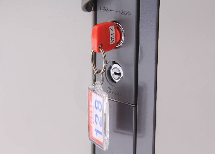 A key-type coin locker. The locker’s number and location are written on the keychain.