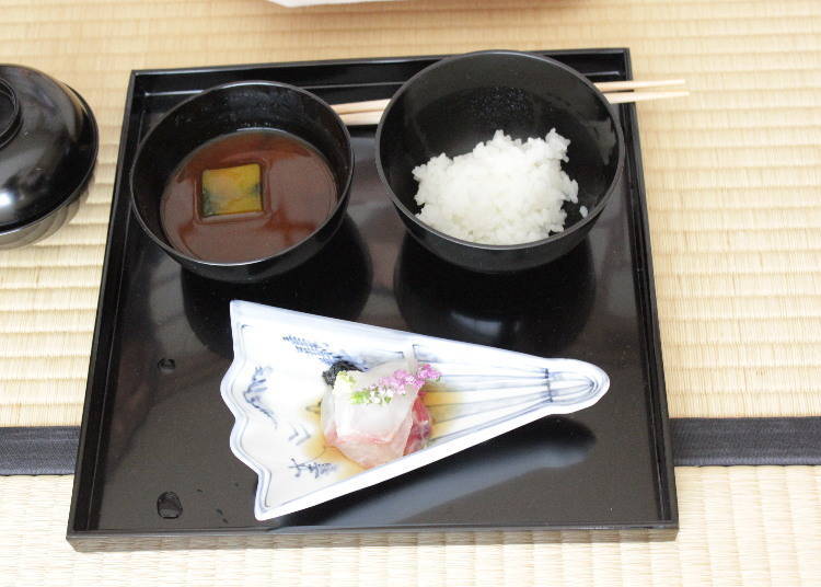 The first course is miso soup, rice, and fish doused in vinegar.