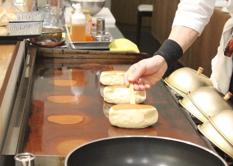 The pancakes are baked right at the counter on a single place, coated in a fine meringue of rice flour and cane sugar.