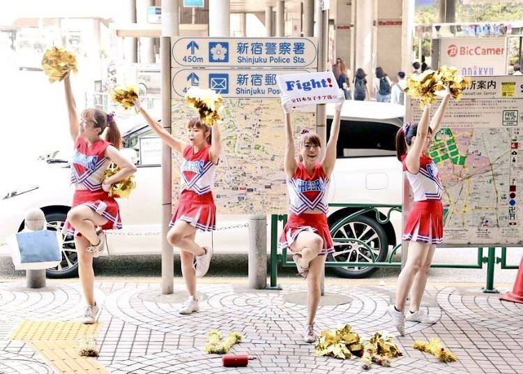 An energetic cheerleading team encourages commuters in the morning at Shinjuku Station’s West Exit.
