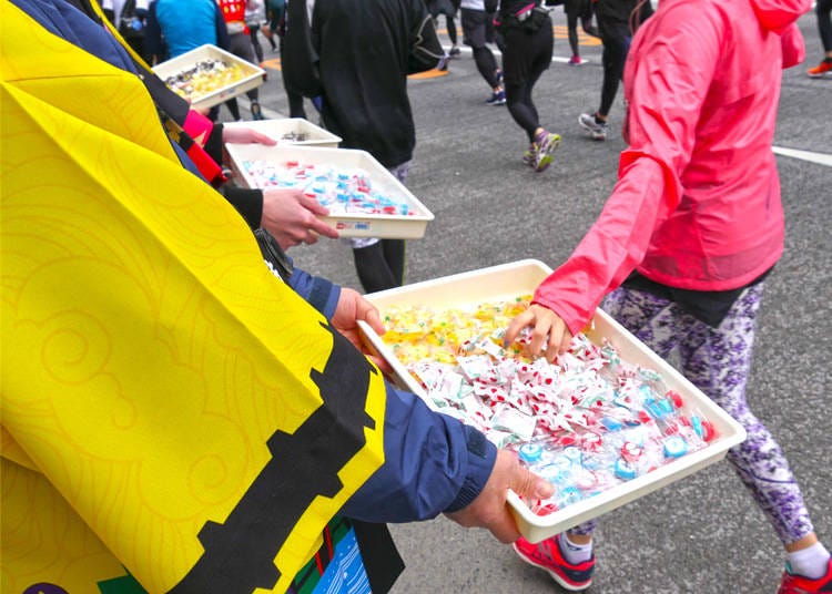 Volunteers passing out electrolyte hard candy