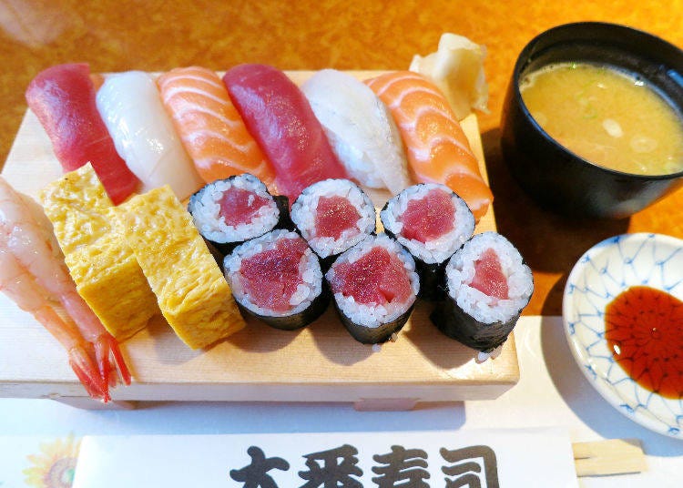 「超值午餐（握壽司 附味噌湯）」（800日圓）。上排左起為鮪魚、花枝、鮭魚、鮪魚、比目魚、鮭魚。下排左起為甜蝦、煎蛋捲、鐵火捲。擺放壽司的容器因外表像木屐，因此被稱作「GETA」