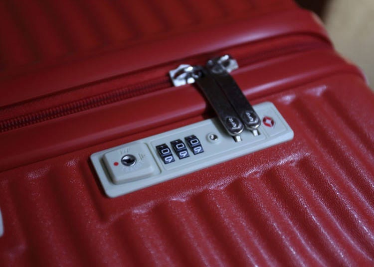 The suitcase is opened with a zipper and it has a TSA lock.
