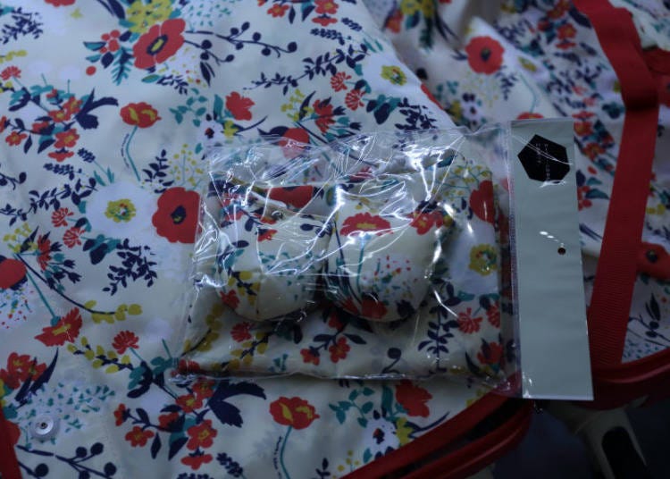 The interior of the red suitcase has a colorful floral pattern on the inside. The covers for the wheels are of the same design.
