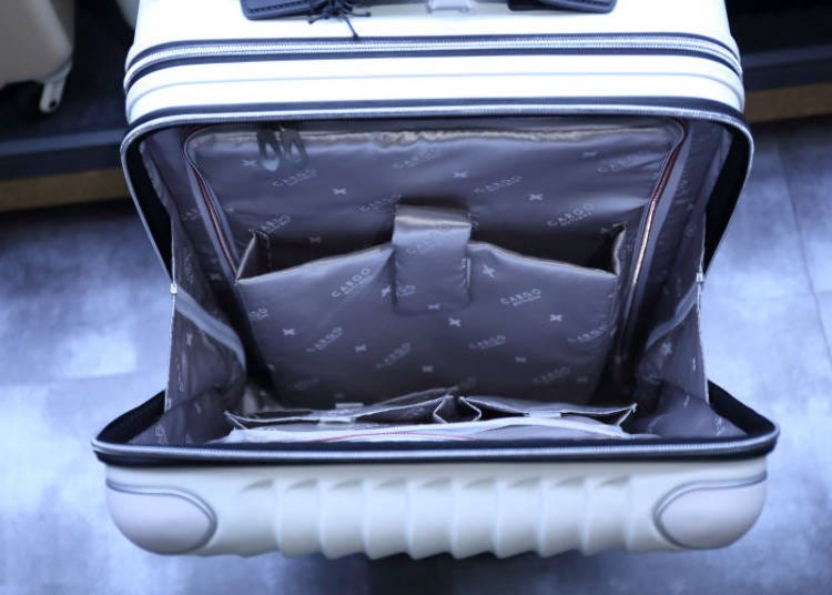 The front-open suitcase. In addition to the laptop pocket, it also has several smaller pockets for chargers and devices.