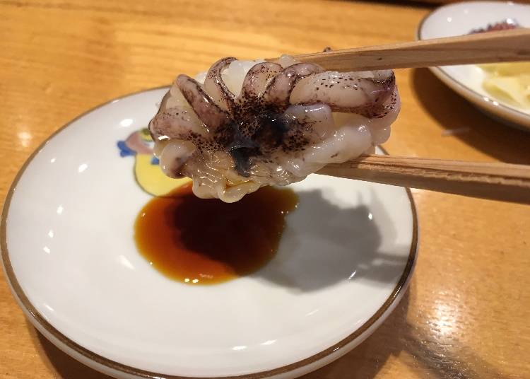 Turn the nigiri to the side and dip the topping.