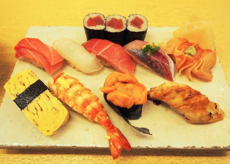 Top (from left to right): 3 pieces of hosomaki sushi, bluefin tuna, spotted halibut from Miyagi, bluefin tuna, horse mackerel from Kagoshima, blood clam from Yamaguchi / Bottom (from left to right): homemade fried egg sushi, shrimp from Oita, sea urchin from Hokkaido, conger eel from Tokyo Bay