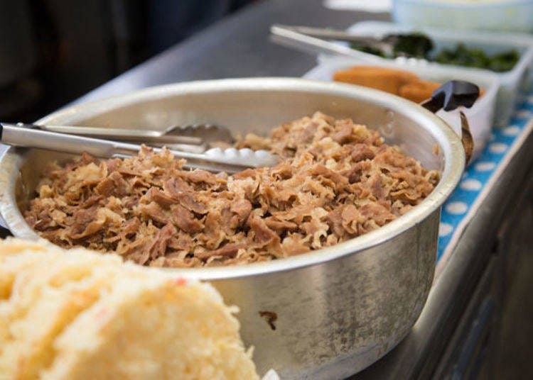 Stewed beef simmering in a large pot, ready to enhance every bowl.