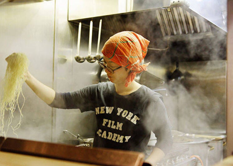 The tuna-kotsu bowl features thin, straight noodles, here boiled by the sous chef Yukie Sato.