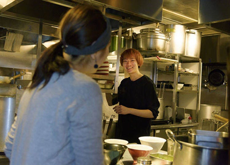 A blonde guy in the kitchen, a woman with a hairband serving the guests. It really feels like a café.