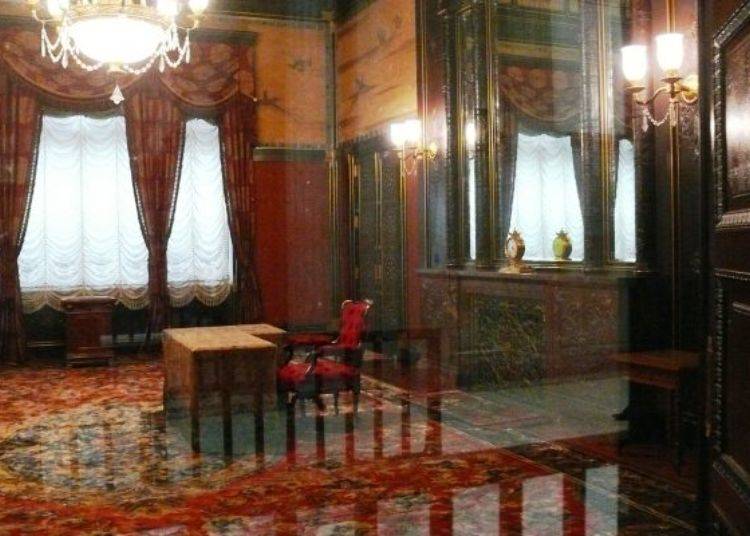 The Emperor’s resting room. The floor is adorned with a hand-woven silk carpet. Right behind the chair is an electric fireplace, made with marble from Shizuoka and engraved with a floral pattern.