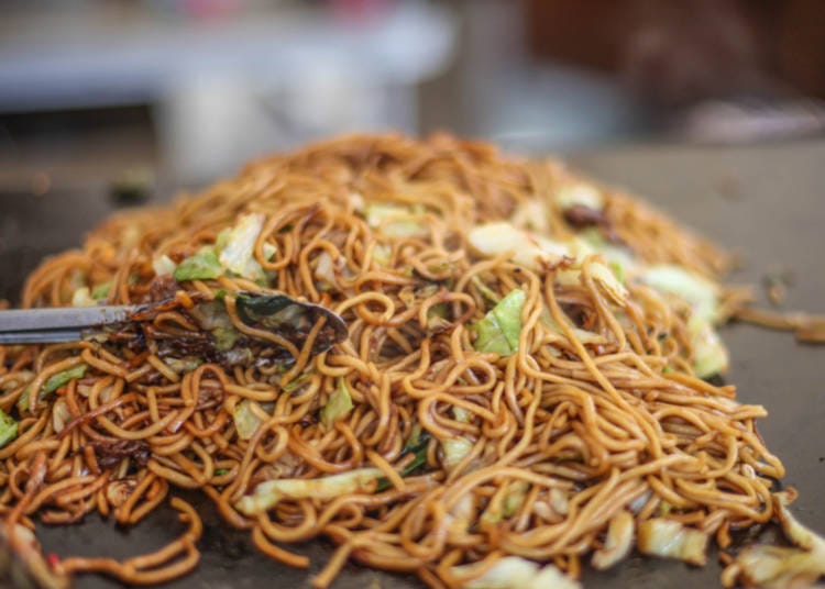 Yakisoba: Stir-fried noodles with vegetables and meat, coated in a savory sauce.