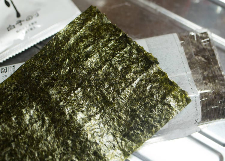 A sheet of dried seaweed. Wrapped around the rice, your hands will stay clean!