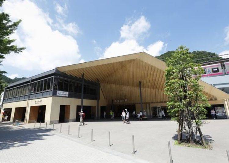 The wooden design of Takaosanguchi Station fits the lush, natural scenery.