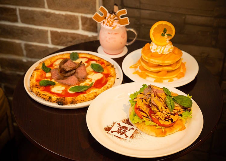 Tuck into Luffy’s Lots of Meat Open Sandwich (bottom right), Luffy’s Favorite Beef Pizza (left), and Nami’s Tangerine Custard Pancake (top right). There is also a special menu that changes with the month to mark the birthday of each One Piece character.