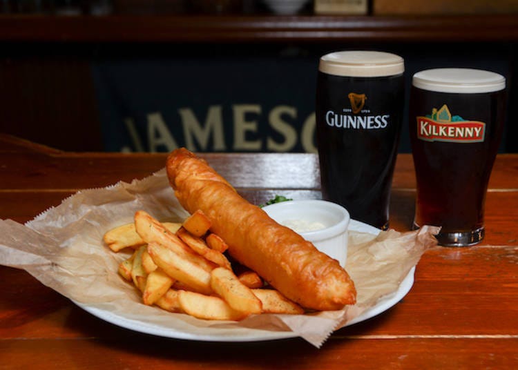 The bar's most popular dish, "Fish and Chips" posing with a couple of Irish beer