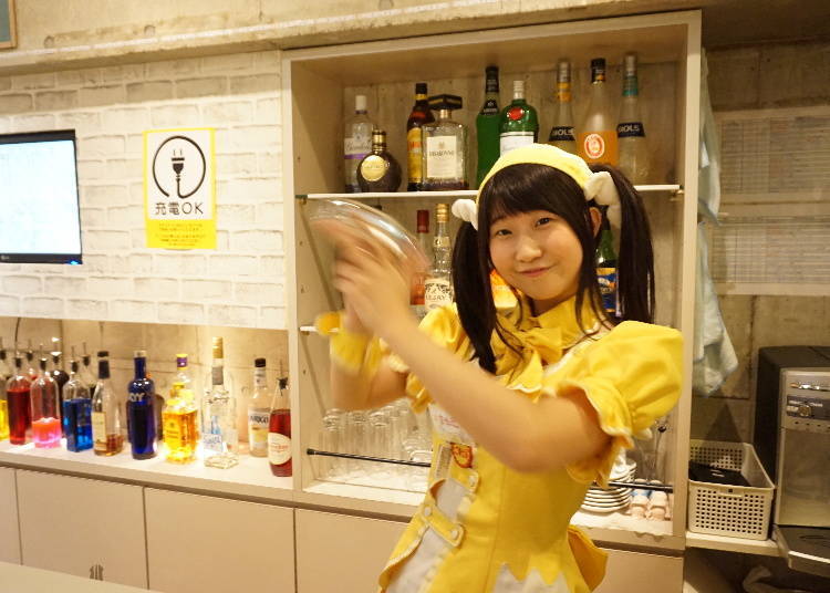 A staff showing off her shaker skills as she prepares a cocktail.