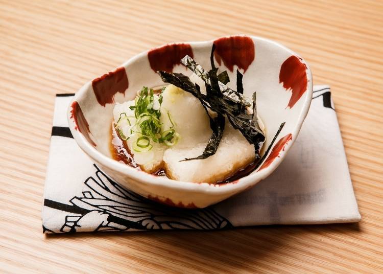 Don't be surprised if you are served a dish you did not order. This is called otoshi (お通し) and is an obligatory appetizer served in lieu of a table charge