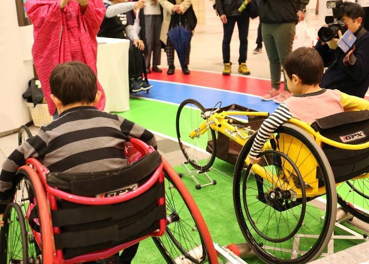 Children try using Paralympic wheelchairs.