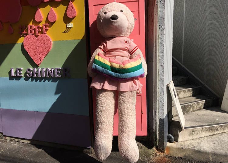 The pink bear in front of the store is a landmark