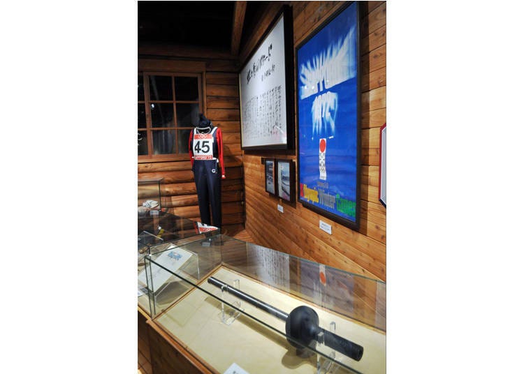 The torch, poster, and uniform from the Sapporo Winter Olympics.
