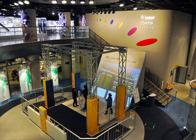 The main attraction of the lower level is the Okurayama Ski Jump simulation, where users receive a score on how their jump goes.