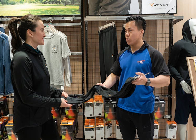 Staff explains the benefits of VENEX Recovery Wear.
