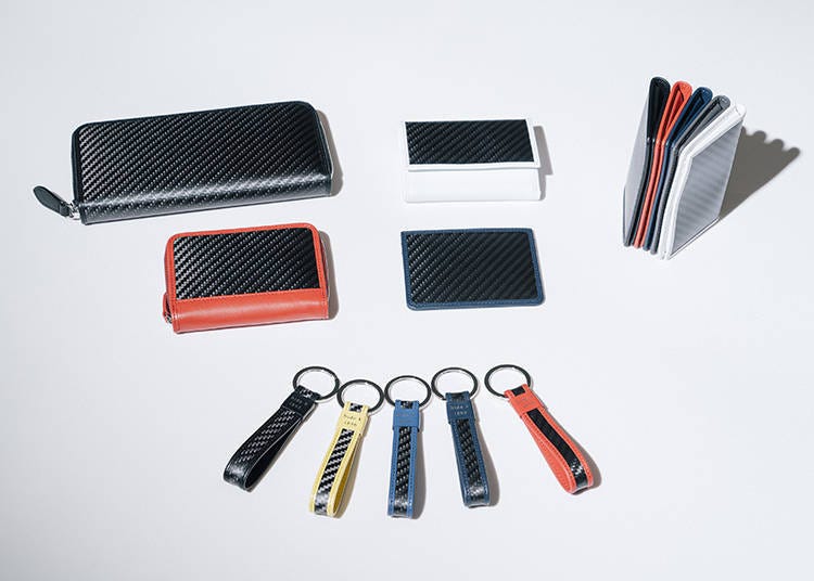 From the top-left, "Round zip wallet": 52,000 yen, "Mini wallet": 35,200 yen, "Card case A": 22,000 yen. From the middle-left, "Mini round zip wallet": 35,200 yen, "Card sleave": 13,200 yen. Below, "Short key holder": 7,700 yen.