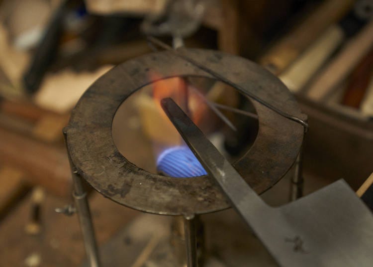 Here you can see the blade base (nakago) being heated before the handle is attached.
