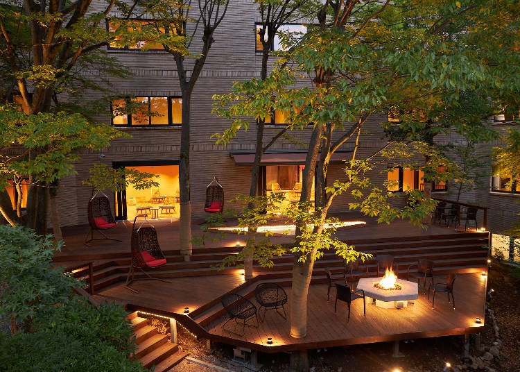 The hot spring foot bath and wooden deck in the courtyard lounge – with a fireplace!