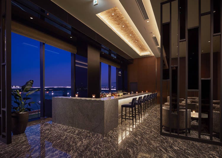 Relish views of the river and night skyline at Bar & Lounge "The Throne"