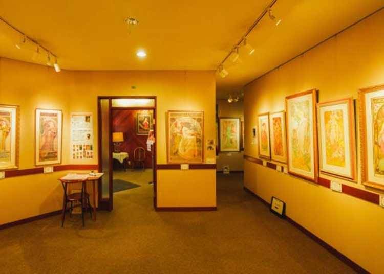 ▲ギャラリーでは、フランスのアール・ヌーヴォーの画家、アルフォンス・ミュシャのコレクターでもある貫さんが蒐集した作品を常時50点ほど展示販売。マスターの絵の解説も楽しめる