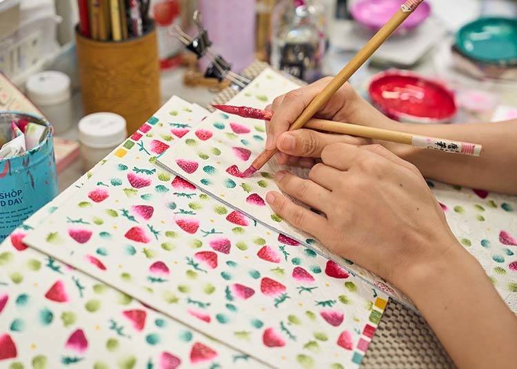 A talented team of artists paint each piece of leather entirely by hand. Pattern: Strawberries.