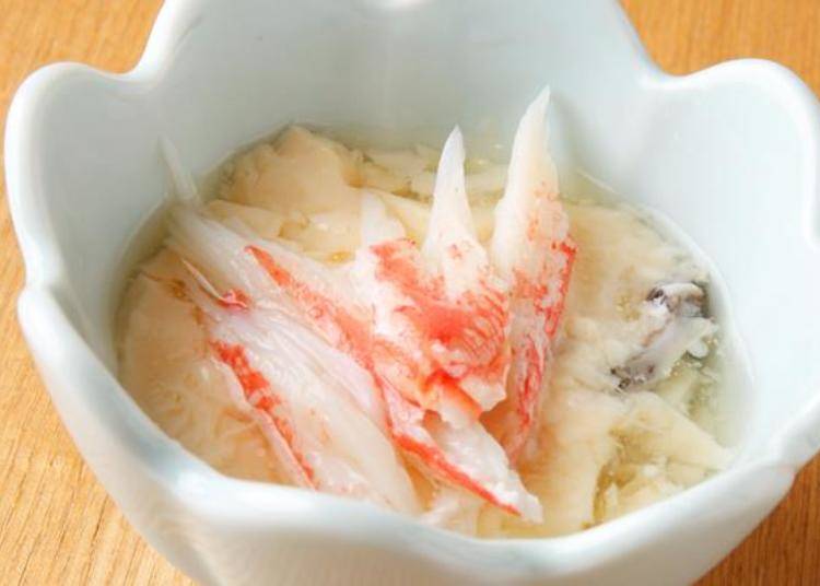 A bite-sized portion of chawanmushi (savory egg custard with crab meat). The skipjack tuna soup broth gives it added flavor!