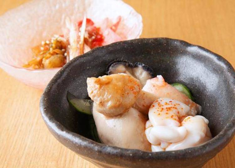 A stewed serving of snow crab claws, matsutake mushroom, oyster, and tachi (soft cod roe). The matsutake gives it a rich flavor