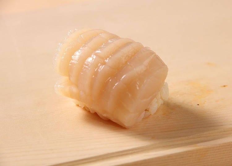 An original way to cut and serve scallops is used to make this Scallop Handroll.