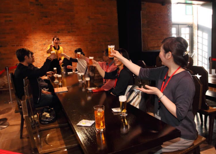 Raising glasses in a toast where “Sapporo!” is said rather than “Cheers!” The cold beer deliciously quenches one’s thirst