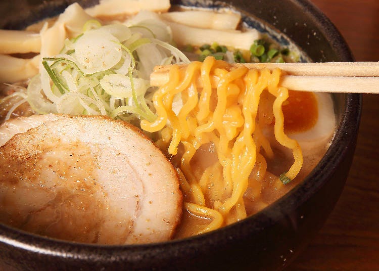 These classic Sapporo ramen noodles are yellowish and wavy. They’re called chidjire men (curly noodles).