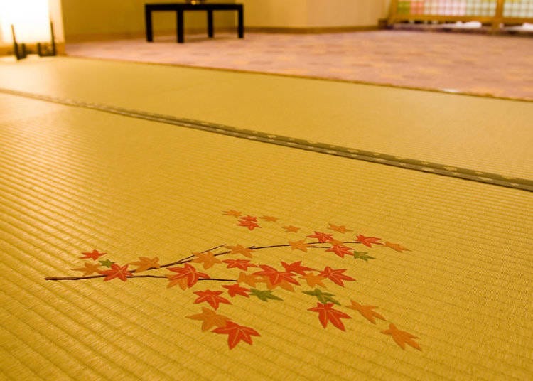 A seasonal embroidered tatami mat greets you.