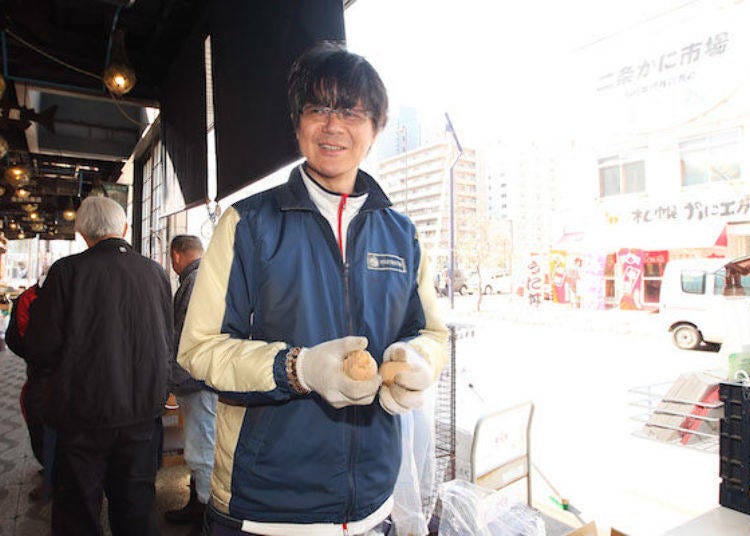 A clerk talking to us while packing potatoes for shipment