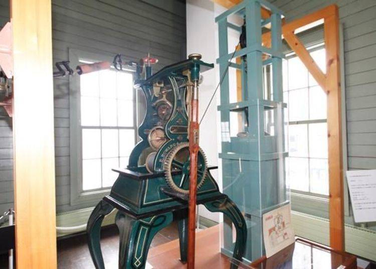 The pendulum tower clock made by the Howard Company in 1928. It does not have a clapper to ring a bell, but it is possible to see how the clock works.