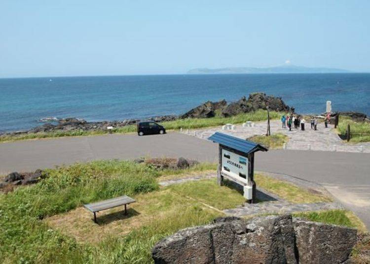 The stamp stand is near where the people are gathered. The island clearly visible in the distance is Rebun Island.