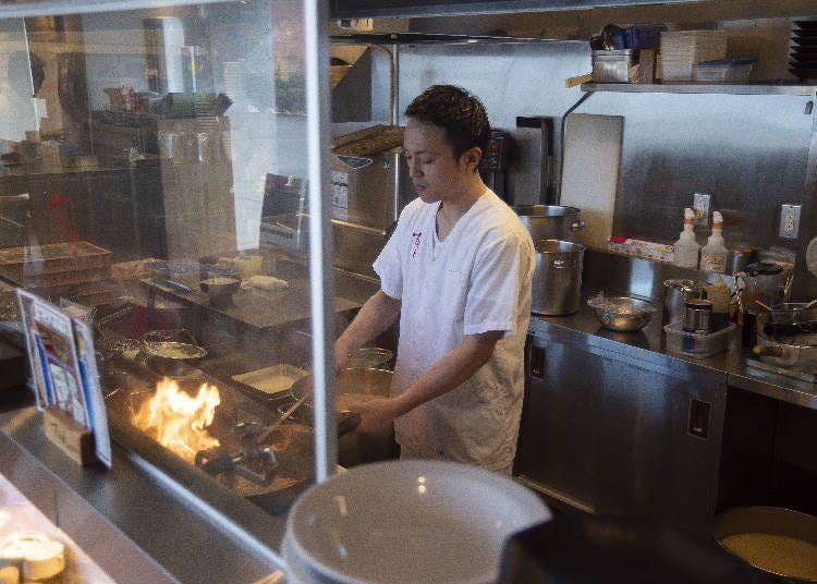 The flames help enhance the aroma in the wok.