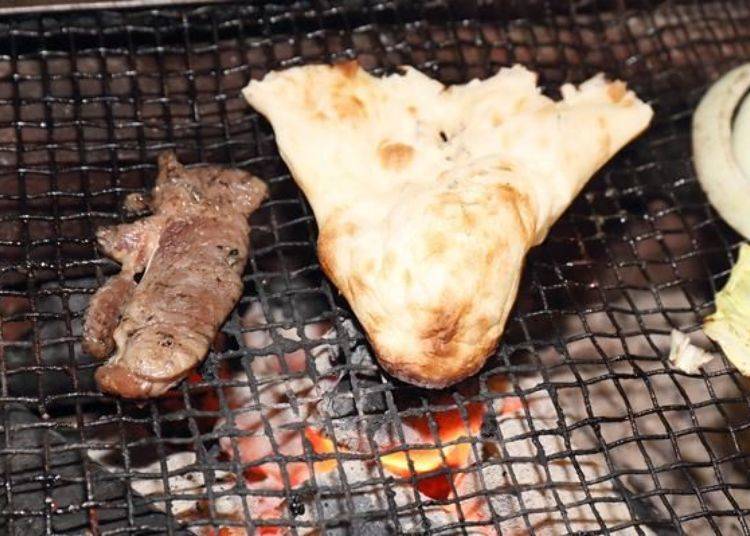 Tear the naan in to bite size and lightly grill it.