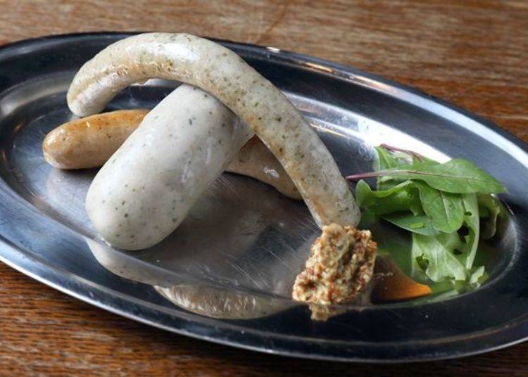 Homemade Sausage Plate. At the very bottom is a normal sausage; above it is a herb sausage, and the fat one in the middle is Weisswurst, a sausage popular in Munich Germany that is eaten after the skin is removed.