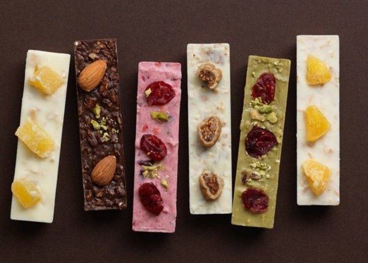 Sante Lien are strips of chocolate with dried fruit and nuts on top. In all there are six types, including the Cranberry x Framboise x Strawberry (central pink)