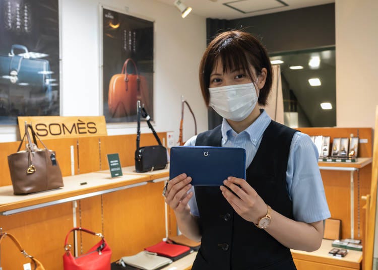 Sales clerk in charge of leather goods. Lately this long wallet has been very popular.