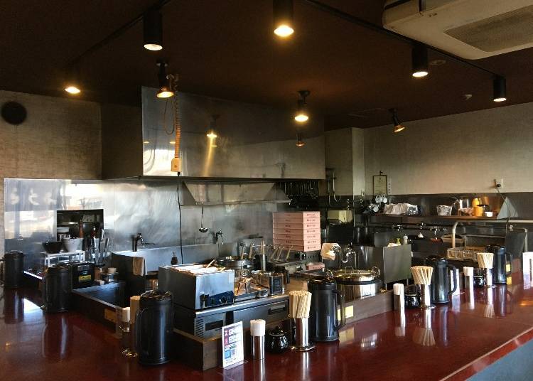 The shop interior consists of a "U"-shaped kitchen counter with seats on three sides