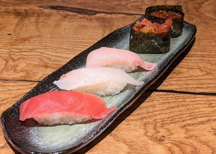 From the bottom left, maguro (tuna), tai (sea bream), hamachi (young yellowtail), kaisen yukke (seafood with raw egg), ikura (salmon roe)