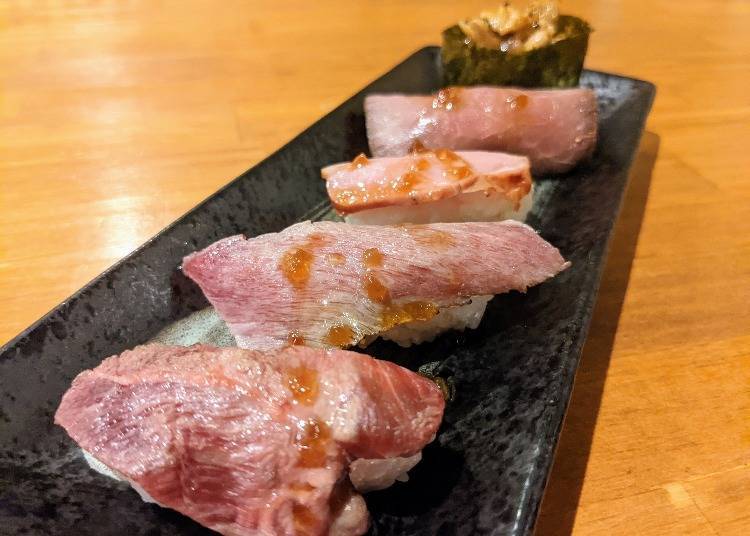 From the bottom left, gyuniku akami (lean beef), misuji (chuck beef), rosuto biifu (roast beef), kamoniku (duck), yakiniku sushi (grilled meat sushi)